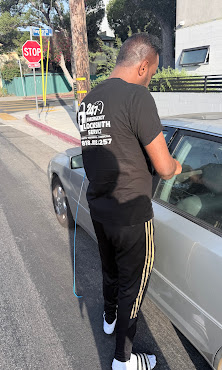 LA Lock Busters unlocking car window with slim jim tool